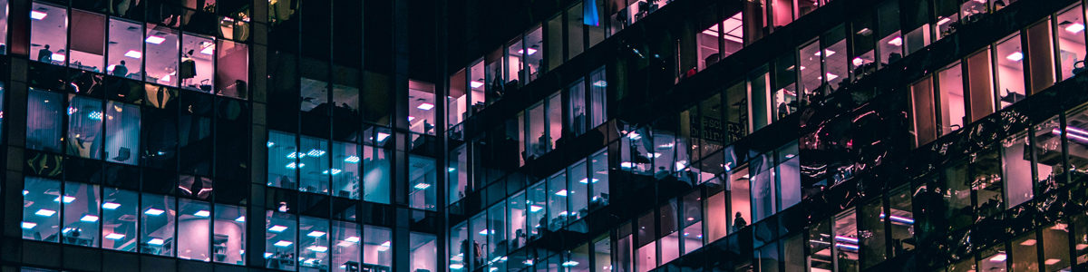 Windows in a tall building lit at night. Photo by Mike Kononov on Unsplash